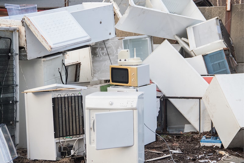 Pile of old and broken household appliances.